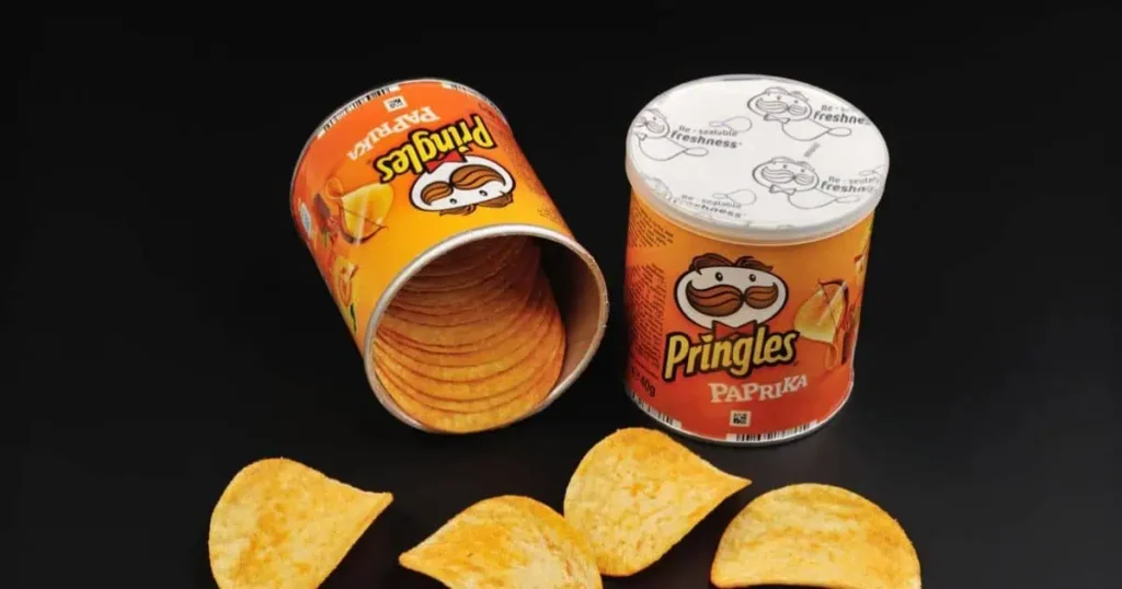 A can of potato chips alongside a box of chips, illustrating the circumference of a Pringles can in a snack display.