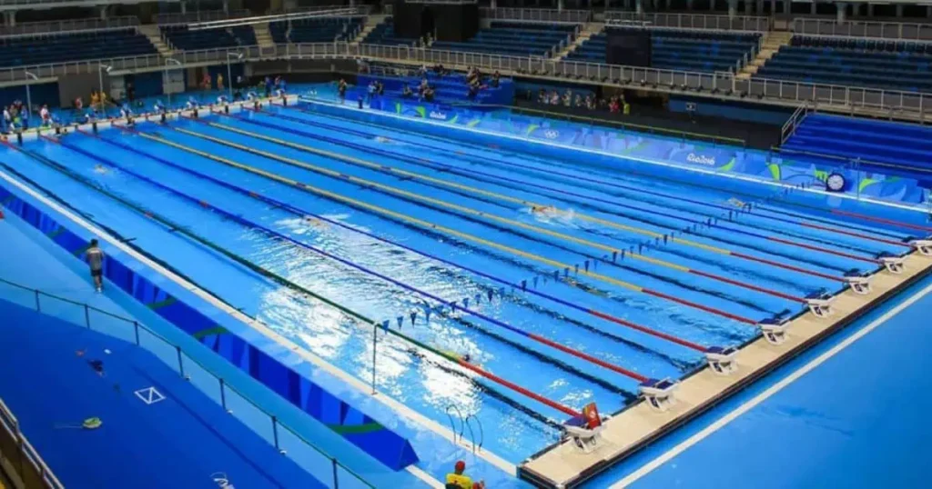 Three Olympic-Sized Swimming Pools showcased at the Olympic Games, featuring clear water and vibrant surroundings.